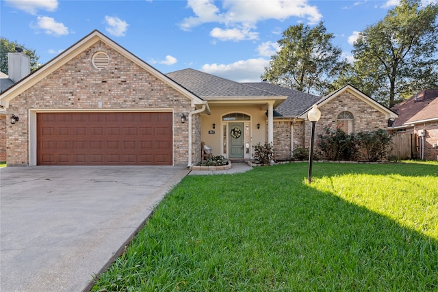 ranch-style home with a garage and a front lawn