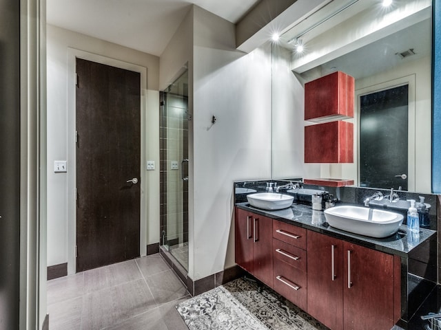 bathroom featuring tile patterned floors, vanity, and an enclosed shower