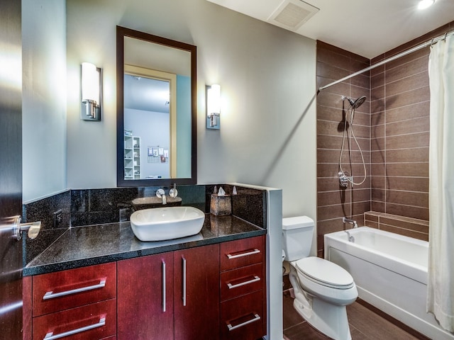 full bathroom with vanity, shower / bath combination with curtain, and toilet