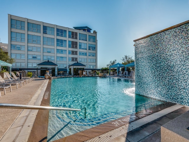 view of swimming pool featuring a gazebo and pool water feature