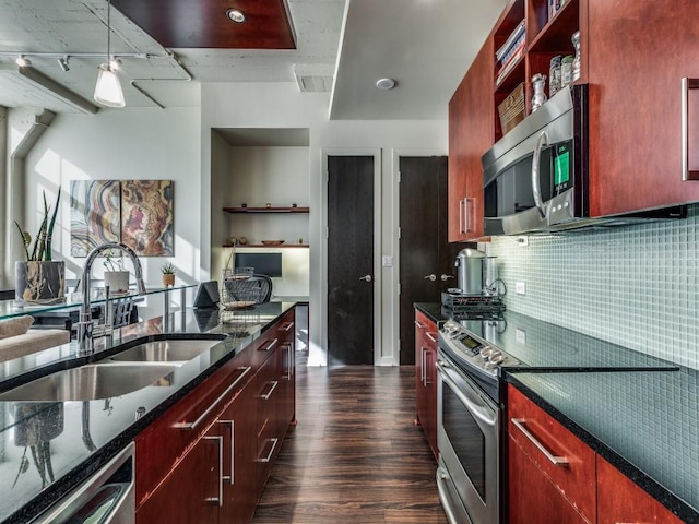 kitchen featuring sink, rail lighting, stainless steel appliances, dark hardwood / wood-style flooring, and decorative backsplash