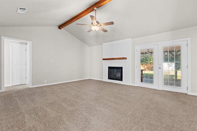 unfurnished living room with carpet flooring, a brick fireplace, vaulted ceiling with beams, and ceiling fan