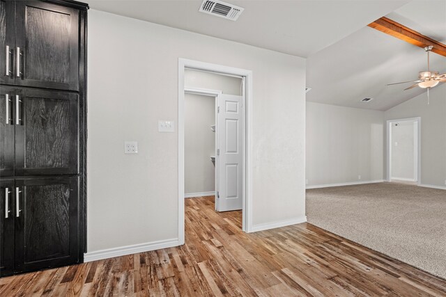 unfurnished room featuring light wood-type flooring, lofted ceiling, and ceiling fan