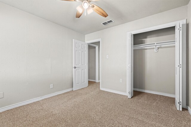 unfurnished bedroom with a closet, light carpet, and ceiling fan