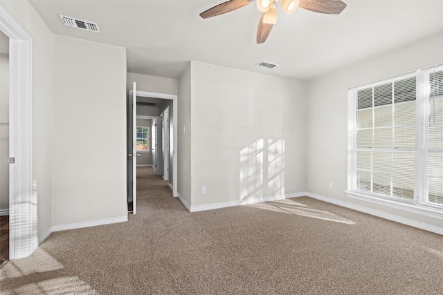 spare room with carpet and ceiling fan