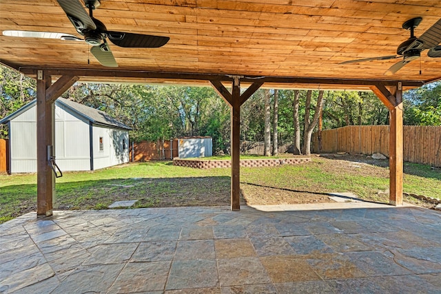 view of patio / terrace with a shed and ceiling fan