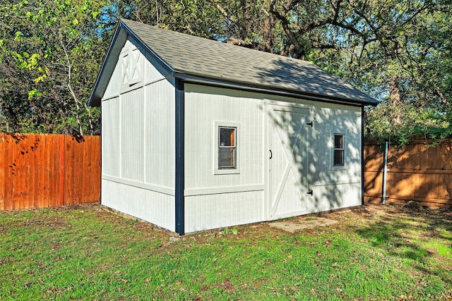 view of outbuilding featuring a lawn