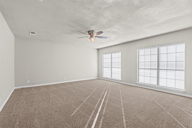 empty room with carpet, a textured ceiling, and ceiling fan