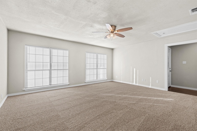 spare room featuring a textured ceiling, carpet flooring, and ceiling fan