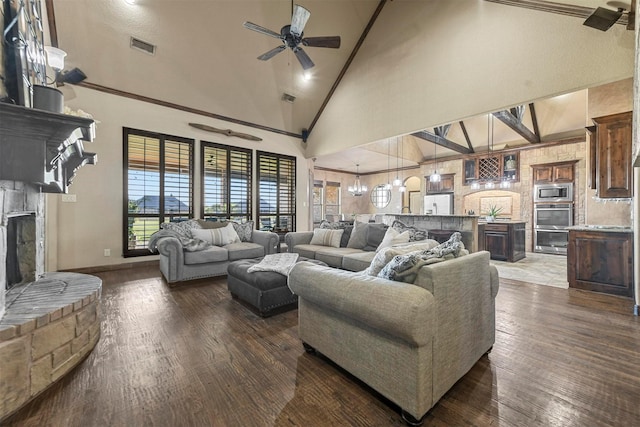 living room featuring dark hardwood / wood-style floors, ceiling fan with notable chandelier, and high vaulted ceiling