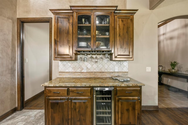 13401 Moorhouse Way, Justin, TX 76247 - bar featuring a dry bar, wine cooler, arched walkways, baseboards, and decorative backsplash