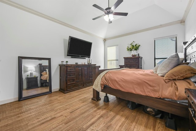 bedroom with crown molding, vaulted ceiling, light hardwood / wood-style floors, and ceiling fan