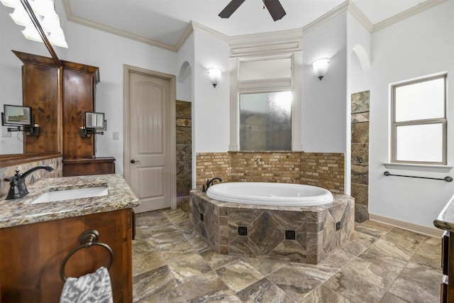 bathroom featuring vanity, tiled tub, ornamental molding, and ceiling fan