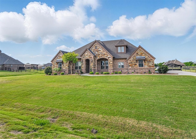 13401 Moorhouse Way, Justin, TX 76247 - french country style house with fence, stone siding, and a front yard
