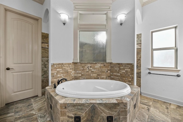 bathroom with tiled tub and a textured ceiling