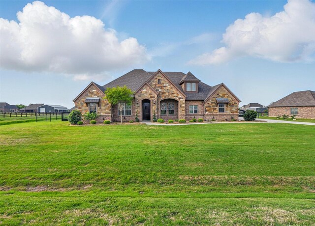 13401 Moorhouse Way, Justin, TX 76247 - french country style house featuring fence, stone siding, and a front yard