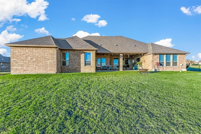 13401 Moorhouse Way, Justin, TX 76247 - back of property with a lawn, brick siding, a patio, and a shingled roof