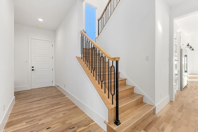 stairs featuring hardwood / wood-style flooring