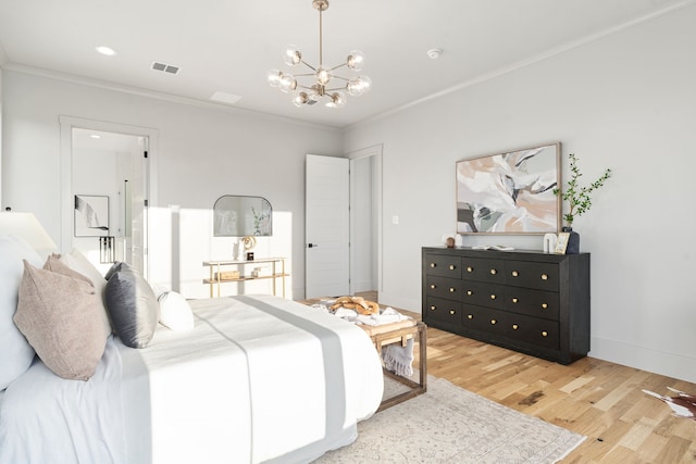 bedroom featuring ornamental molding, light hardwood / wood-style flooring, and an inviting chandelier