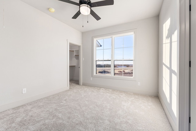 spare room featuring light carpet and ceiling fan