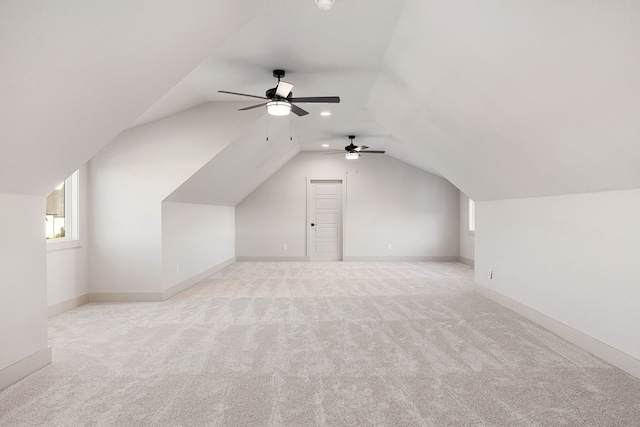 bonus room featuring ceiling fan, lofted ceiling, and light colored carpet