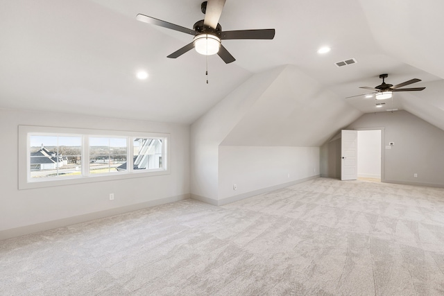 bonus room featuring ceiling fan, light carpet, and lofted ceiling