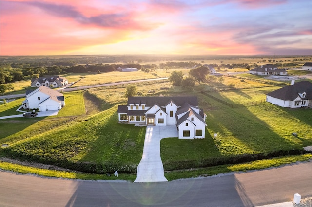 aerial view at dusk featuring a rural view