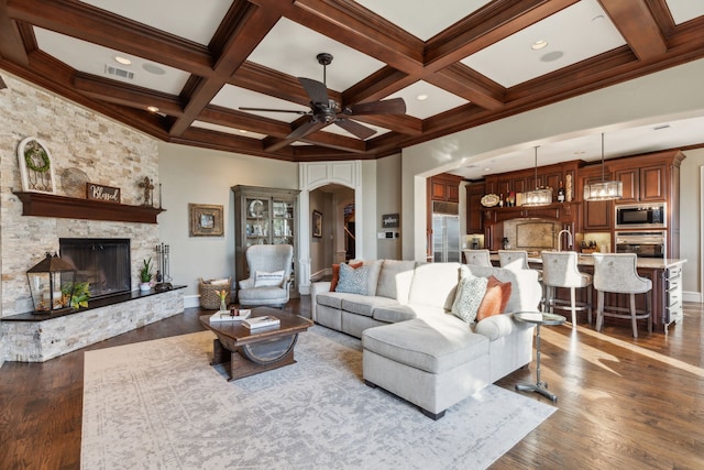 living room featuring beamed ceiling, hardwood / wood-style floors, and coffered ceiling