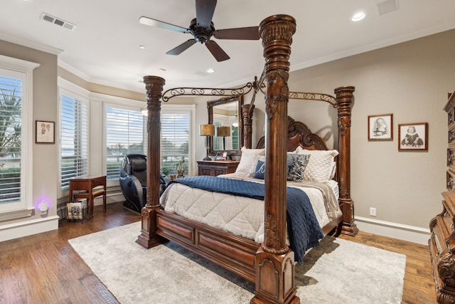 bedroom with ceiling fan, dark hardwood / wood-style floors, and crown molding