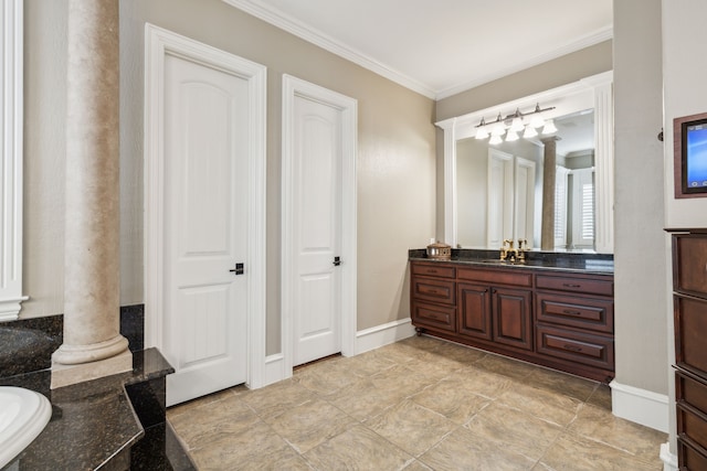 bathroom with decorative columns, vanity, and ornamental molding