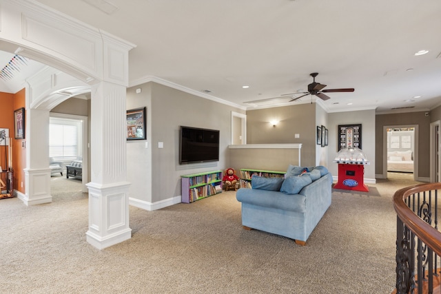 carpeted living room with decorative columns, ceiling fan, and ornamental molding