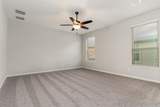 carpeted spare room featuring ceiling fan