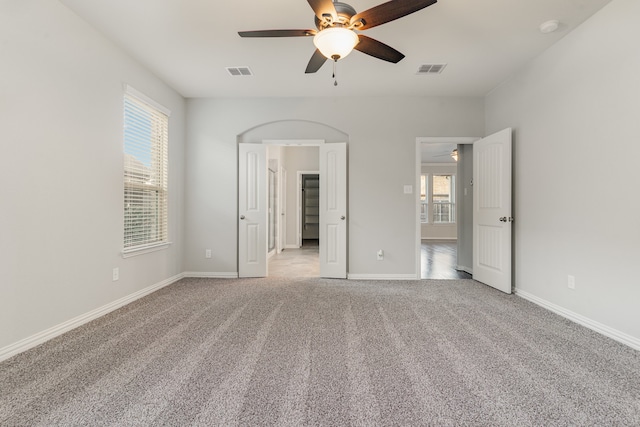 unfurnished bedroom with ceiling fan and light carpet