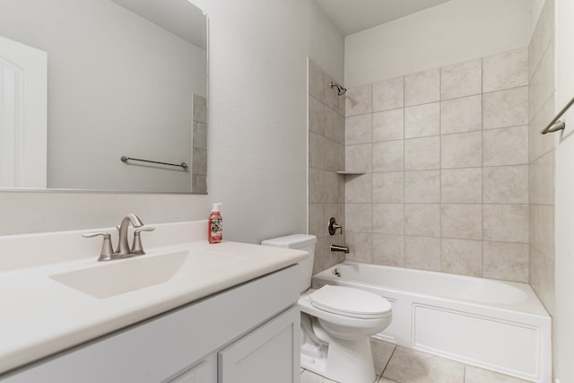 full bathroom with vanity, tile patterned floors, toilet, and tiled shower / bath combo