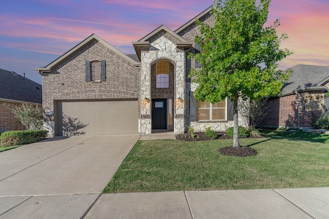 view of front of property featuring a garage and a yard