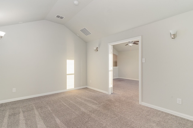 spare room with ceiling fan, carpet flooring, and vaulted ceiling