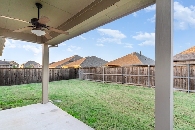 view of yard with ceiling fan and a patio area