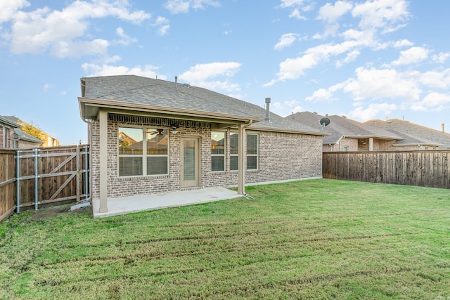 rear view of house with a patio, a yard, and ceiling fan