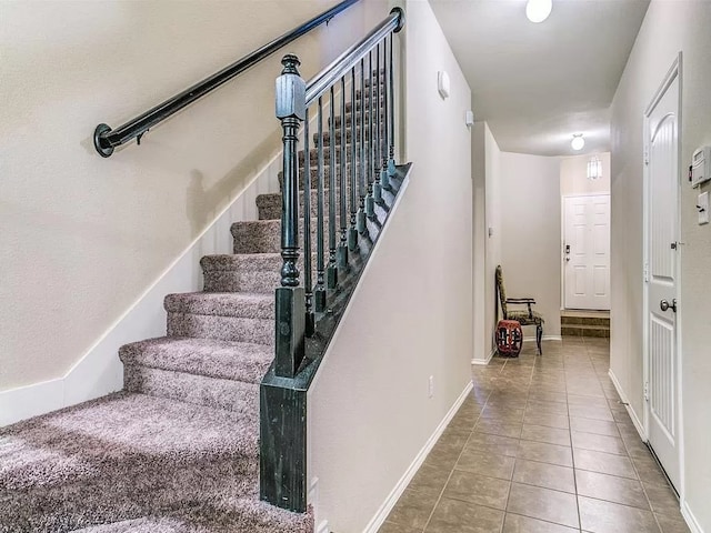 staircase with tile patterned flooring