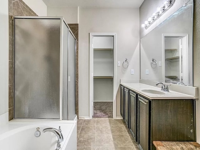 bathroom featuring vanity, tile patterned floors, and separate shower and tub