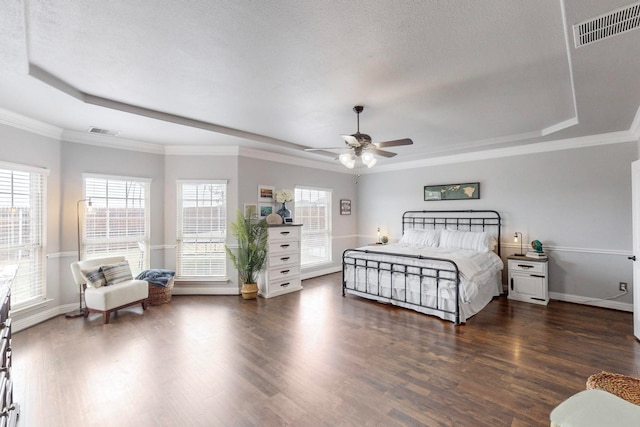 bedroom with ornamental molding, dark wood-type flooring, and ceiling fan