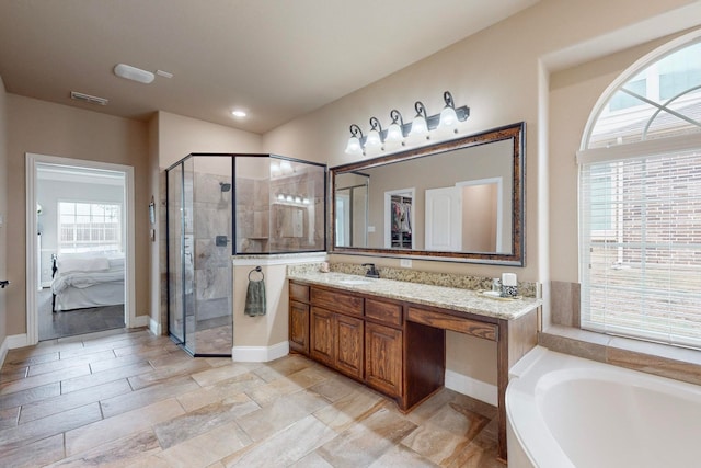 bathroom with vanity, plenty of natural light, and shower with separate bathtub