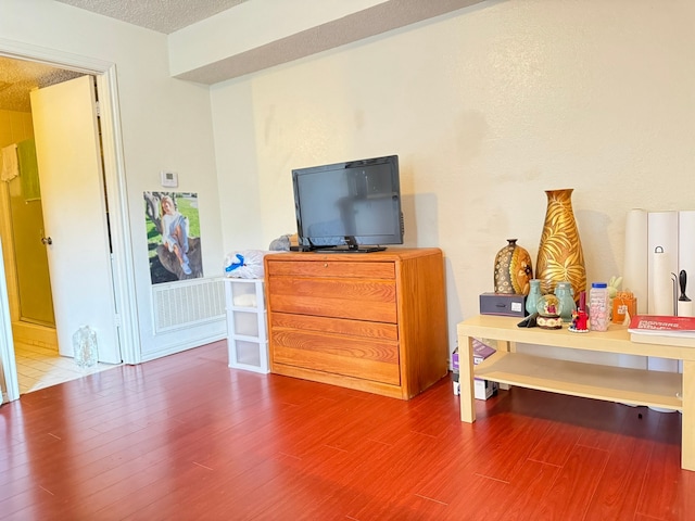 bedroom featuring hardwood / wood-style floors and a textured ceiling