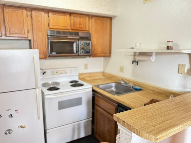 kitchen featuring white appliances and sink