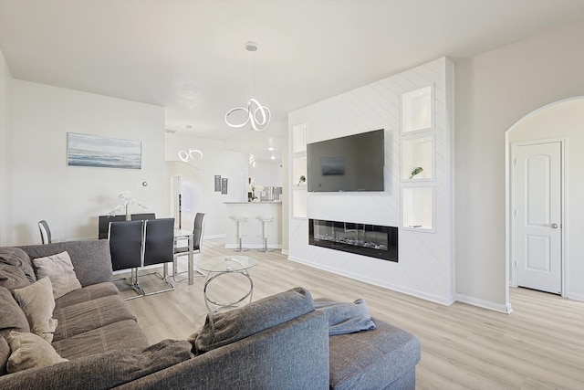 living room with a fireplace and light hardwood / wood-style flooring