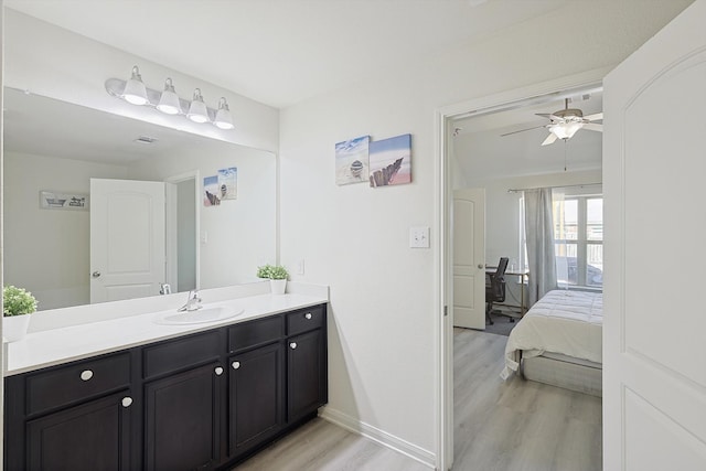 bathroom with vanity, hardwood / wood-style floors, and ceiling fan