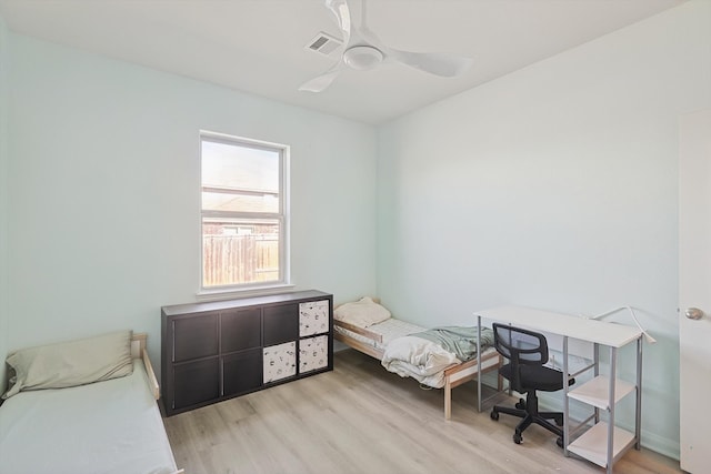 bedroom with light hardwood / wood-style floors and ceiling fan