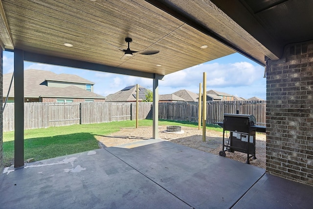 view of patio with a fire pit and ceiling fan