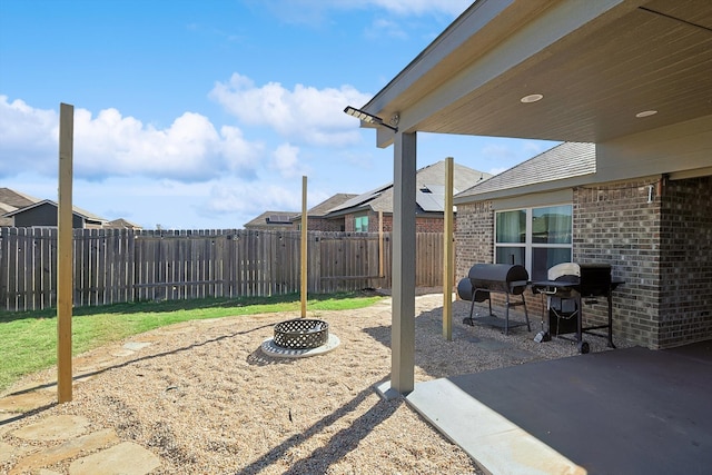 view of yard featuring a fire pit and a patio area