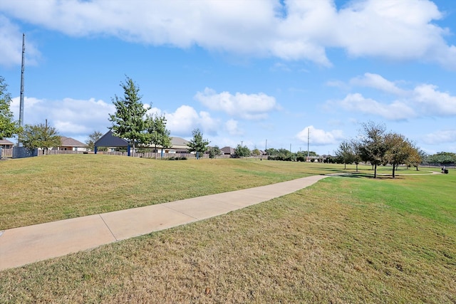 view of property's community featuring a yard